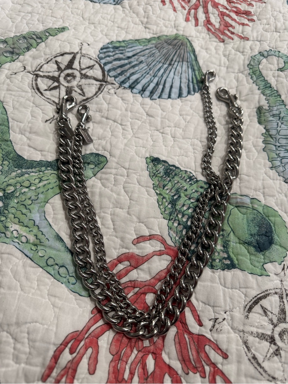 Two silver Coach bag chains